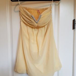 From Paris! Short, pale yellow dress.